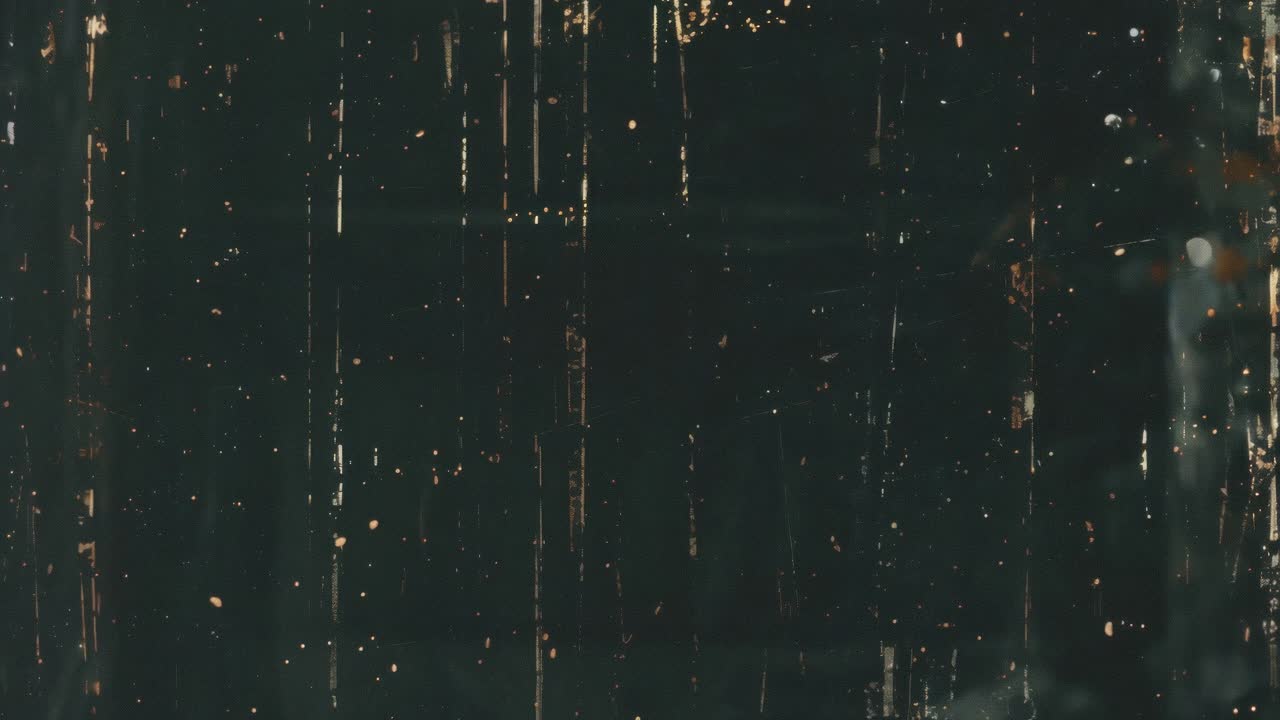 Vintage film effect with scratches and dust on a dark background, captured from a top-down angle