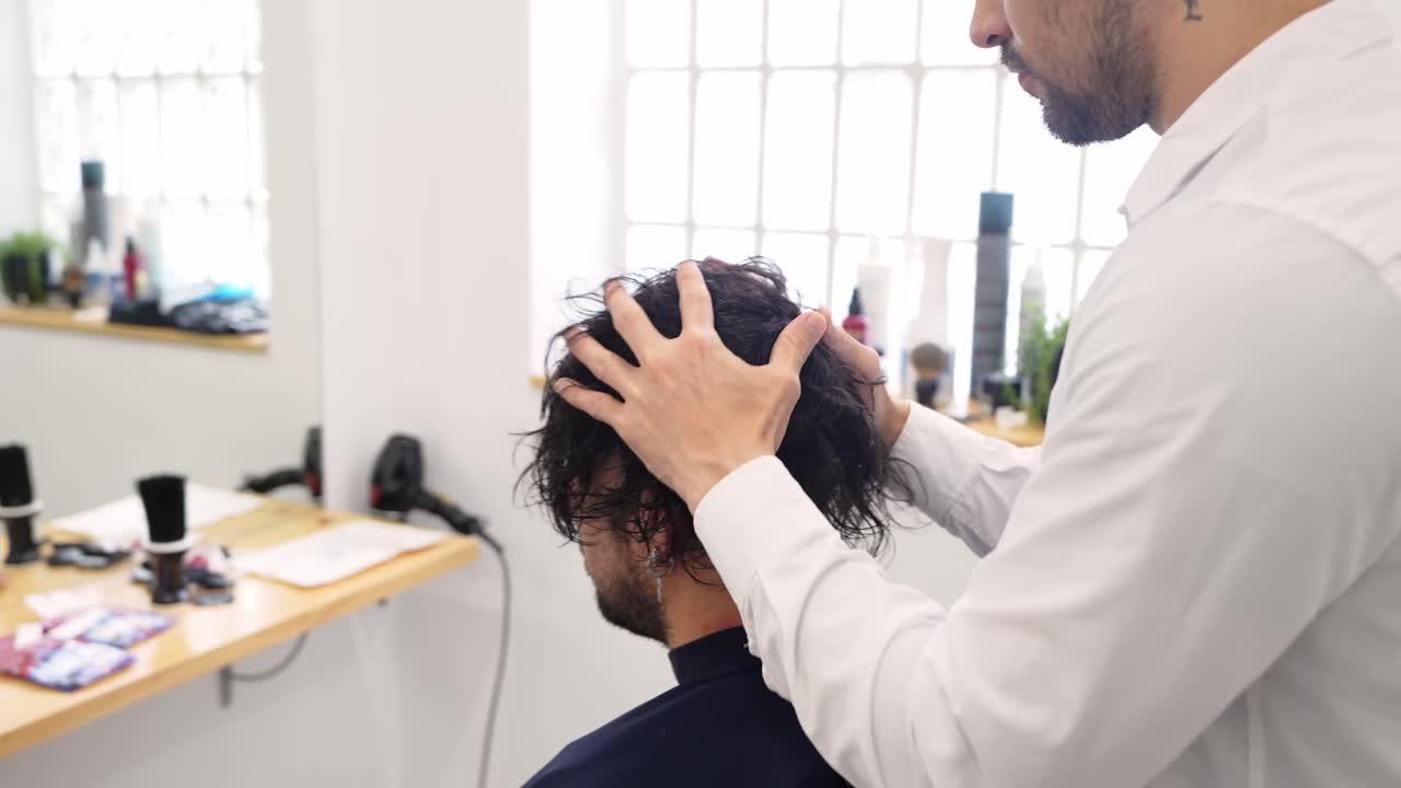 Hairdresser styling a man's hair in a salon