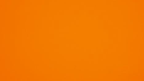 creepy halloween pumpkins falling on a rope and bats fly on orange theme. stop motion