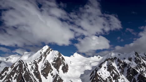 snow-capped mountains under a dramatic sky