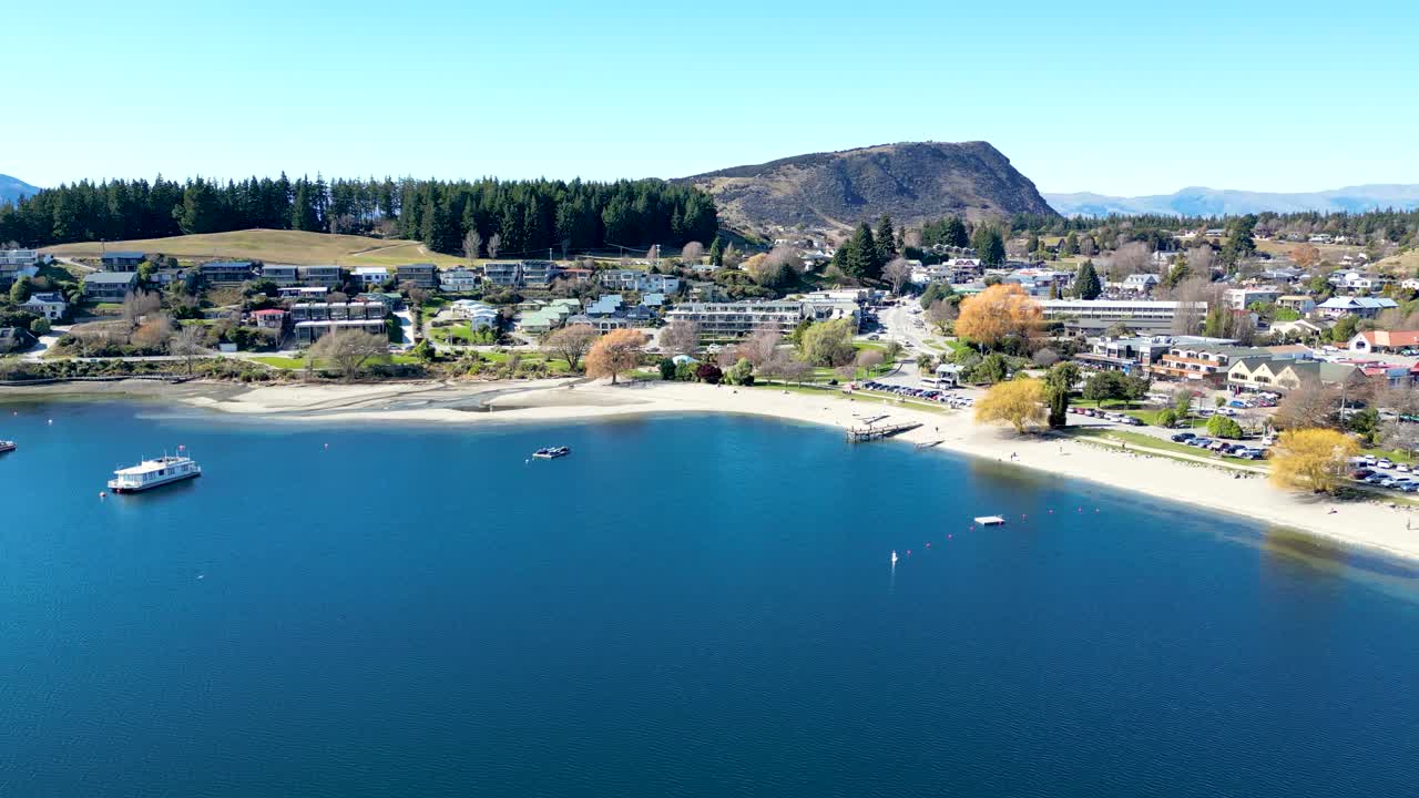 Panning across Lake Wanaka on the South Island of New Zealand against a stunning blue sky