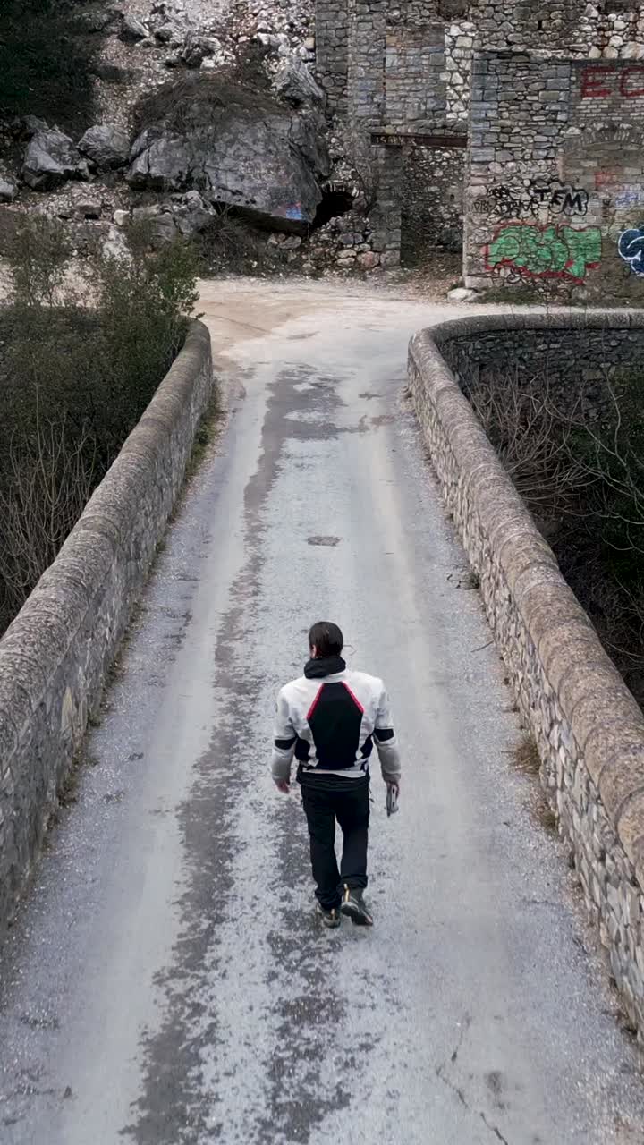 Person walking on an old stone bridge