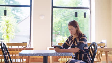 woman using tablet in a cafe