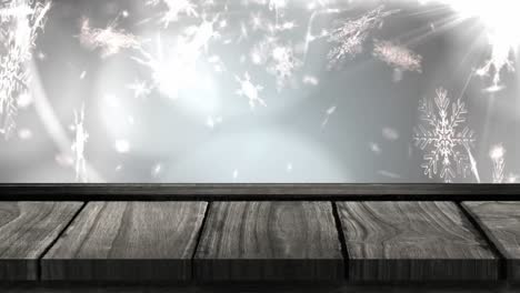 Animation-of-snowflakes-falling-with-wooden-surface-over-grey-background