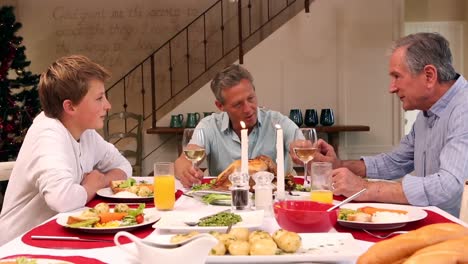 three generation family having christmas dinner together