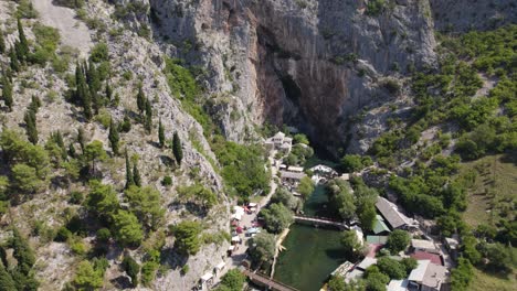 blagaj tekija: cliffside monastery over spring, bosnia aerial flyover