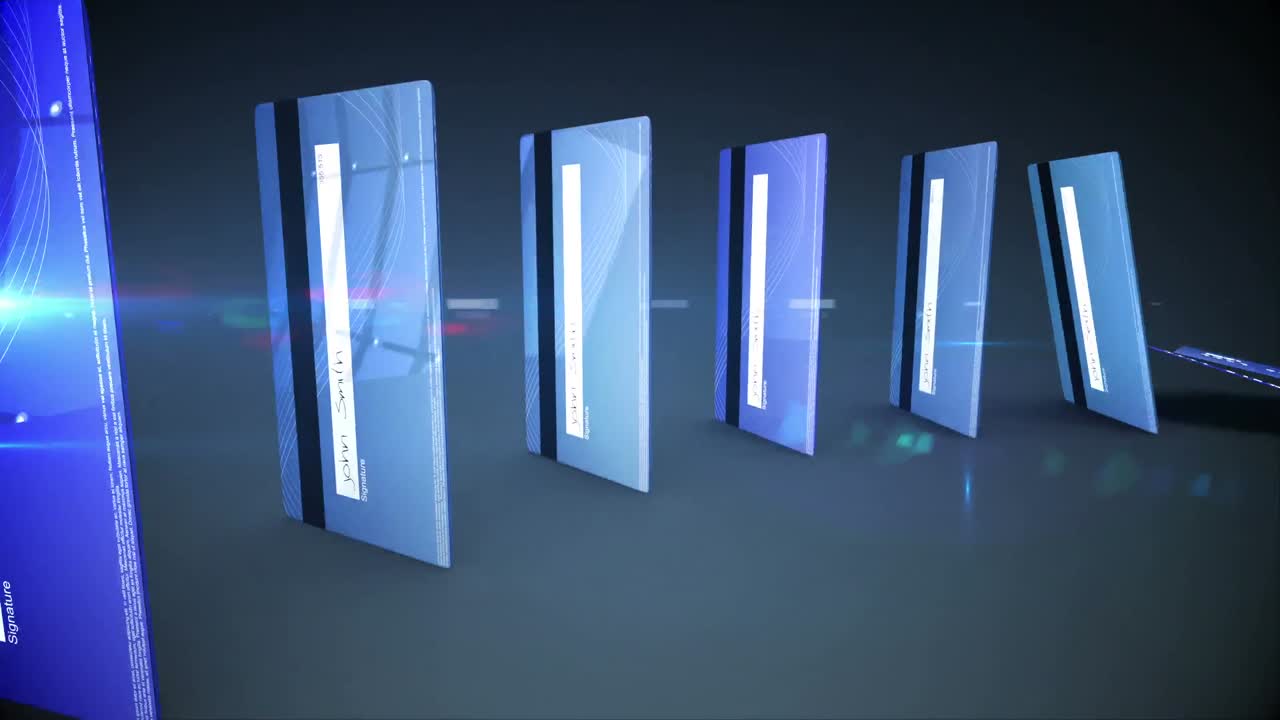 Blue credit cards falling in a circle like dominoes against dark background