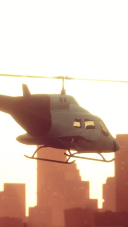 helicopter flying over city at sunset