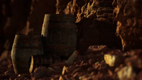 old wooden vintage wine barrels near stone wall in canyon