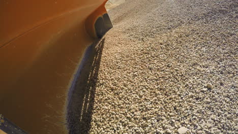 interesting point of view of loading and dumping gravels into a truck, industrial machinery at sand quarry. 4k footage