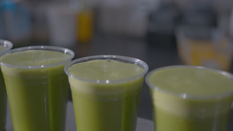 close up high angle of a row of green juices