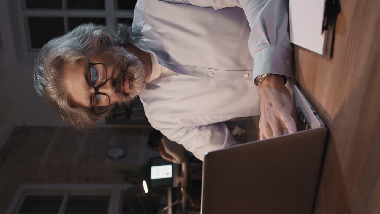 Man Working on Laptop at Night