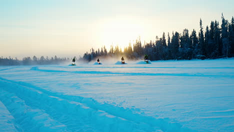 team of snowmobile riders speeding slow motion across snowy arctic circle woodland trail