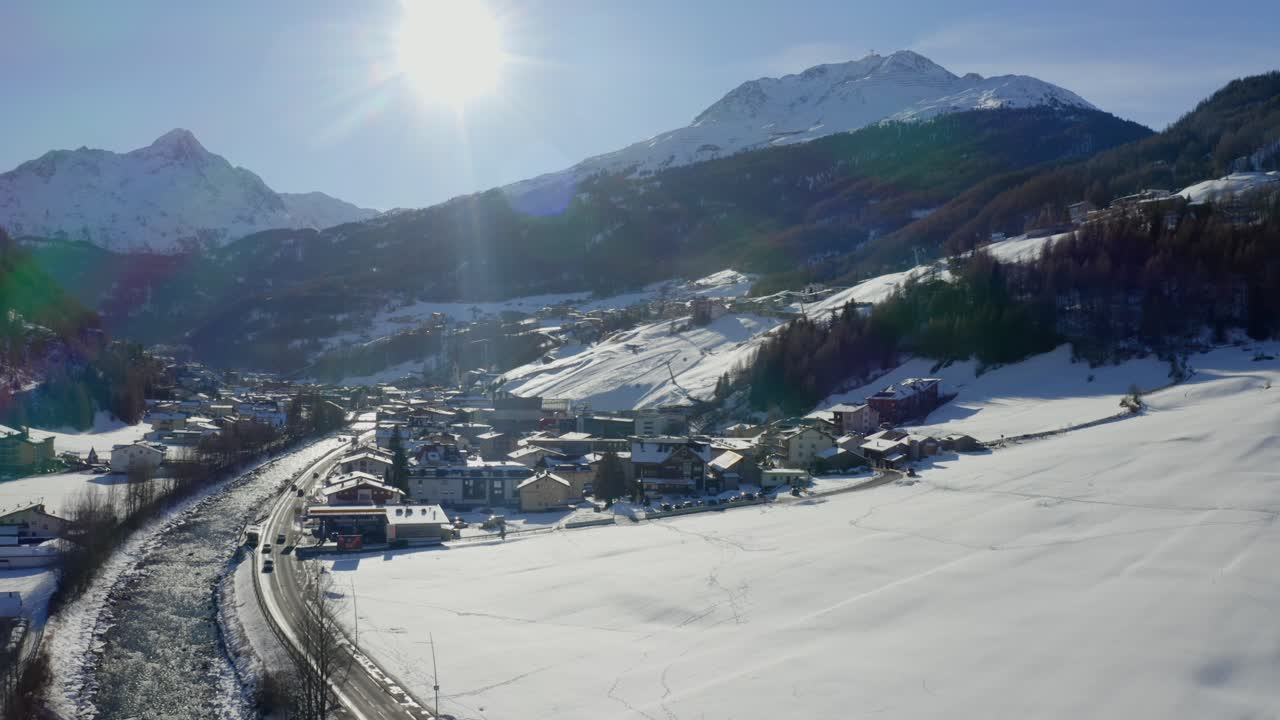Scenic winter view over Sölden with bright sunlight and snowy rooftops nestled in the Ötztal Alps.
