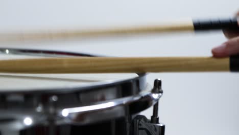 steel-drum-edge-rim-being-played-against-white-background