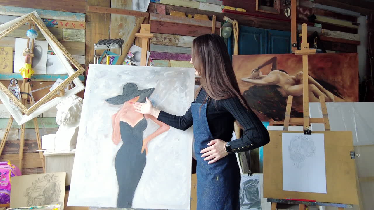 Woman presenting a painting at an art gallery workshop