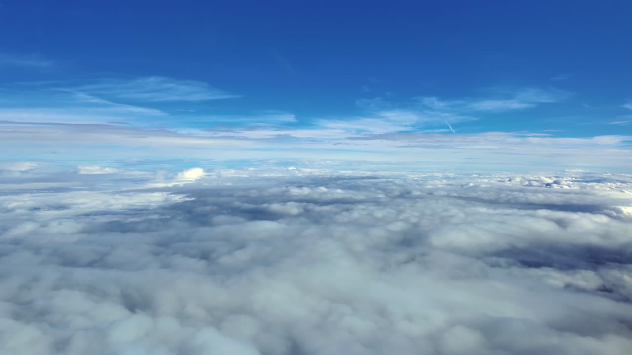 An immersive fighter jet cockpit view taken while flying in the upper atmosphere in a supersonic speed flight under a deep blue sky
