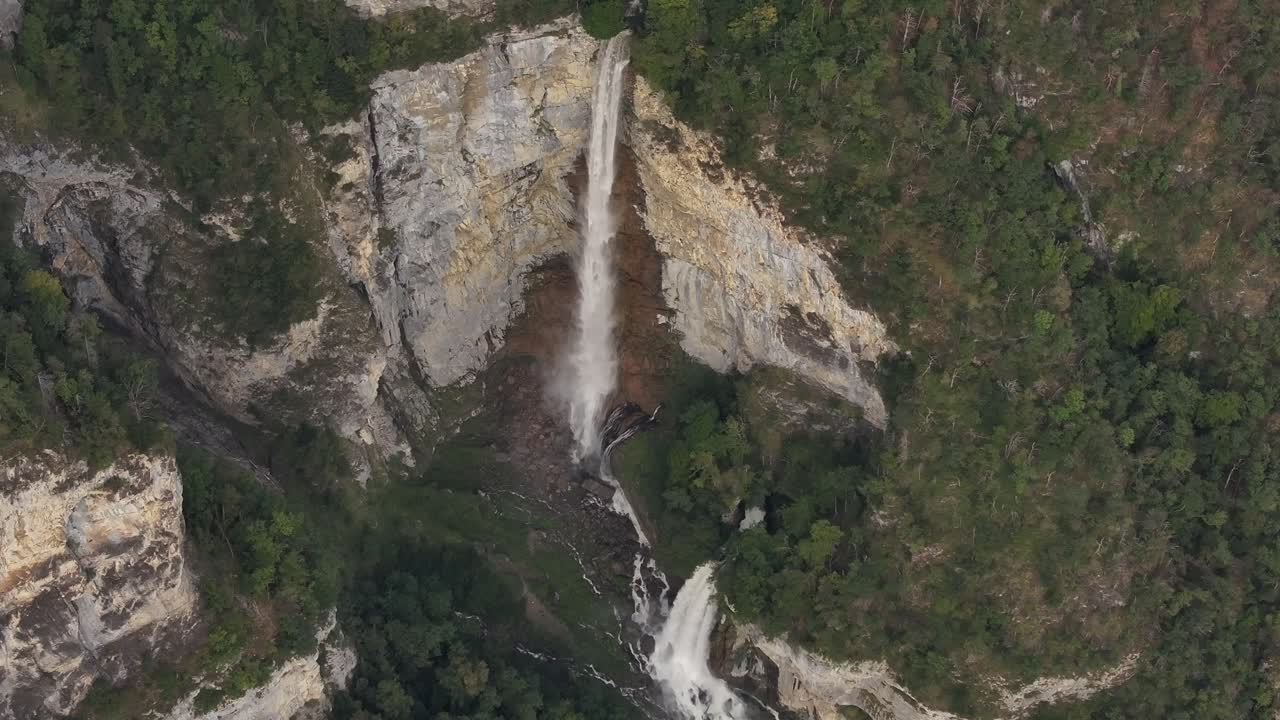 Drone aerial view of Seerenbachfälle waterfall, vibrant green trees in Amden, Betlis, Kanton SG, Switzerland.
