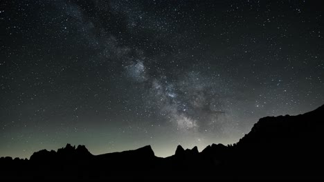 Time-lapse-shot-of-beautiful-night-sky-over-Dolomiti-Mountains-with-flying-stars-and-meteors