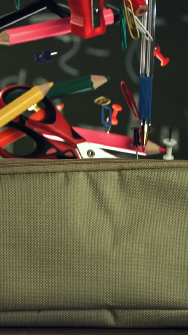 School Supplies Falling into a Pencil Case in Slow Motion