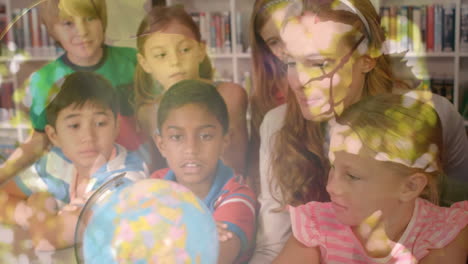 animation of leaves over diverse schoolchildren and teacher looking at globe