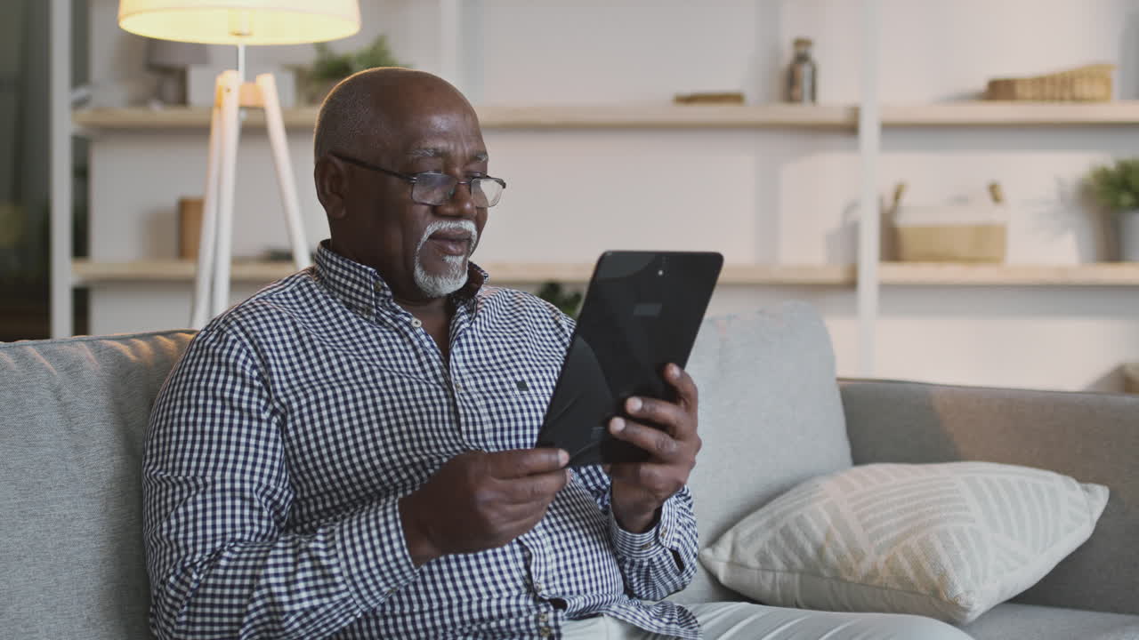 Older African American Man Using a Tablet at Home