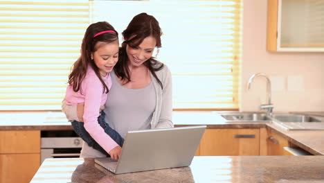 little girl playing with a laptop