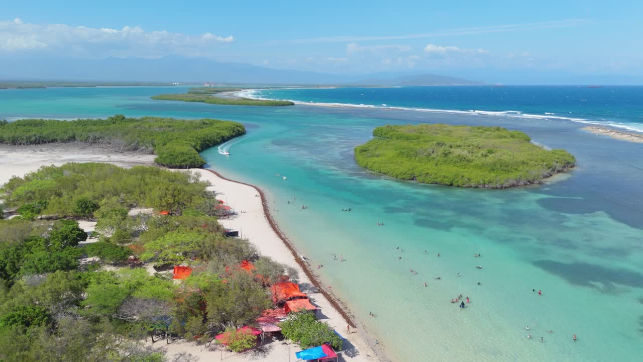 People Swim In Turquoise Blue Water Of Playa Caobita In Summer In Azua, Dominican Republic. - aerial shot