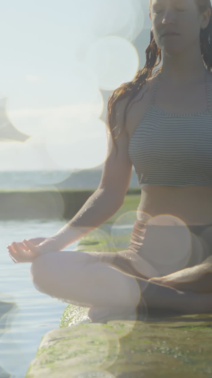 animación de puntos de luz sobre una mujer caucásica practicando yoga y meditando