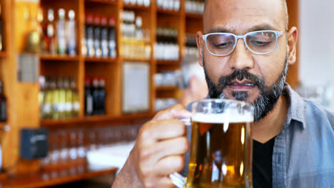 Man-having-glass-of-beer-in-restaurant-4k