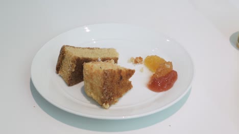 Using-fork-to-eat-gluten-free-cake-in-white-plate-with-homemade-jam