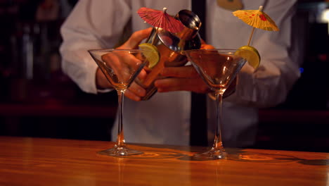 bartender pouring cocktails on counter