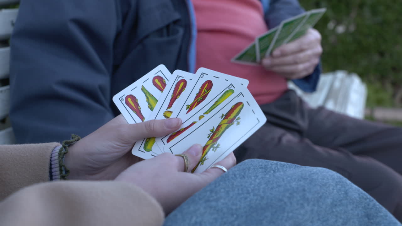 People playing cards outdoors