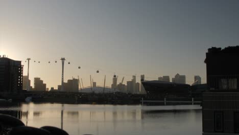 slider shot of the millennium dome and emirates cable car at sunset.view over the lake.