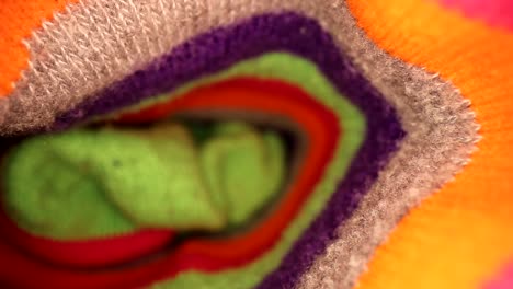 pulling out of a vibrant multi-colored crazy sock with a shallow focus