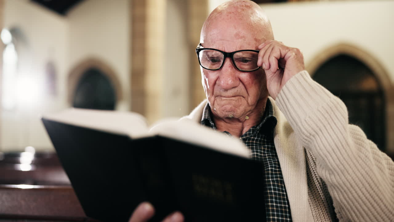 Senior man reading Bible in church