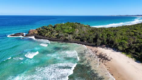 waves crash against hexagonal volcanic rock formations