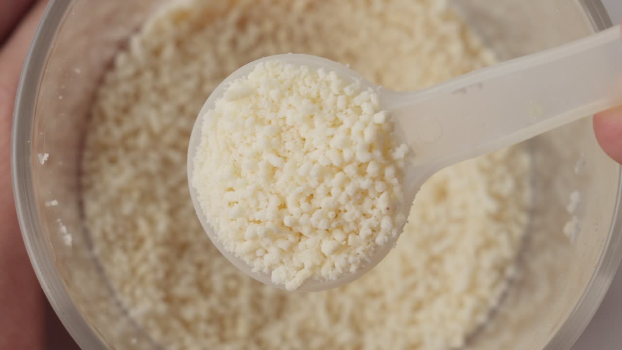 Plastic Spoonful Take Up Powdered Mushroom Seasoning Blend Msg From Container, Top Down View