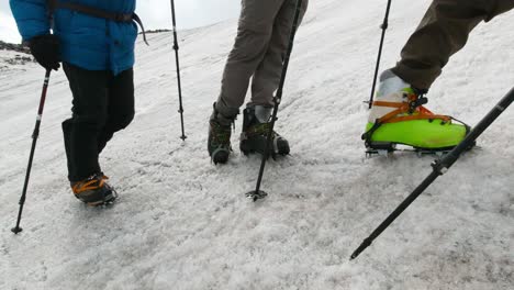 hikers ascending a snowy mountain glacier