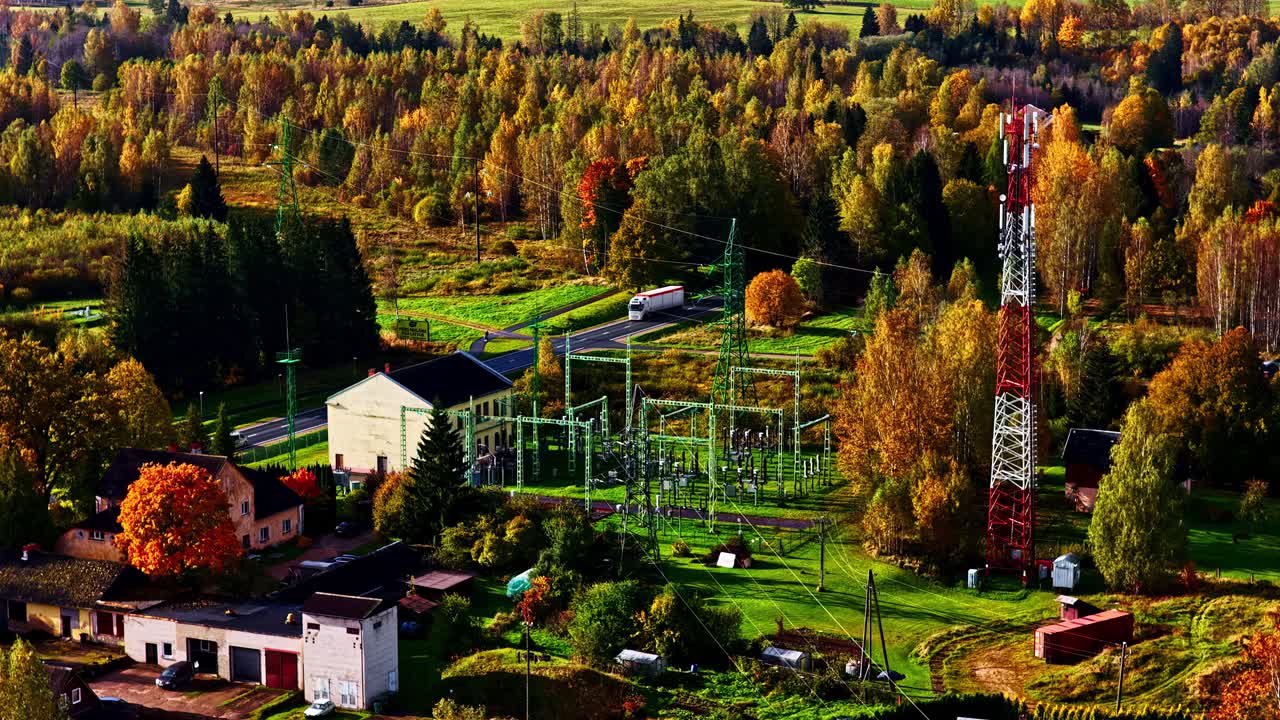 High-voltage tower in a rural area next to the road in Northern Europe
