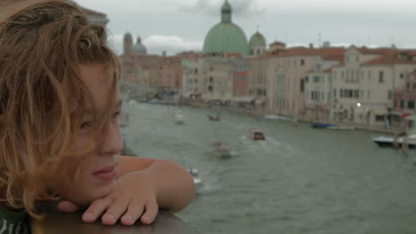 young boy overlooking the grand canal in venice