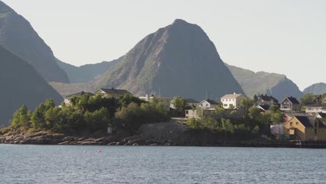 Coastal-Village-Of-Husoy-By-The-Shoreline-Of-Oyfjorden-Fjord-In-Troms,-Norway