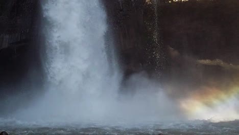 el primer plano en cámara lenta de la cascada con una cámara de 4k es un momento hermoso con un arcoíris y un entorno exótico. la gente está asombrada con este destino turístico de bali, indonesia.