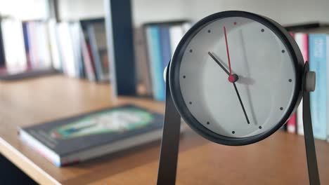 modern clock on bookshelf