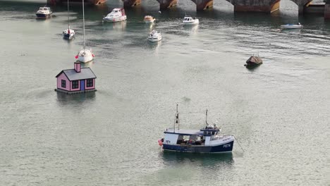 anchored boats at folkestone harbour in folkestone town in kent, england. aerial shot