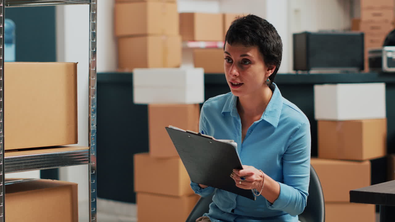 Woman working in a warehouse with boxes
