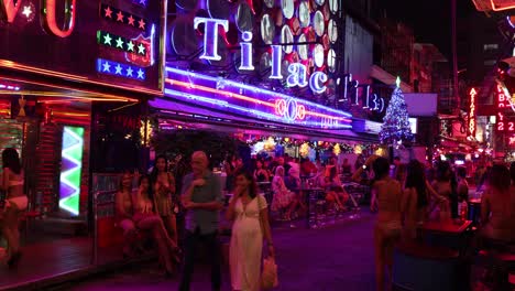 people enjoying nightlife with vibrant neon lights