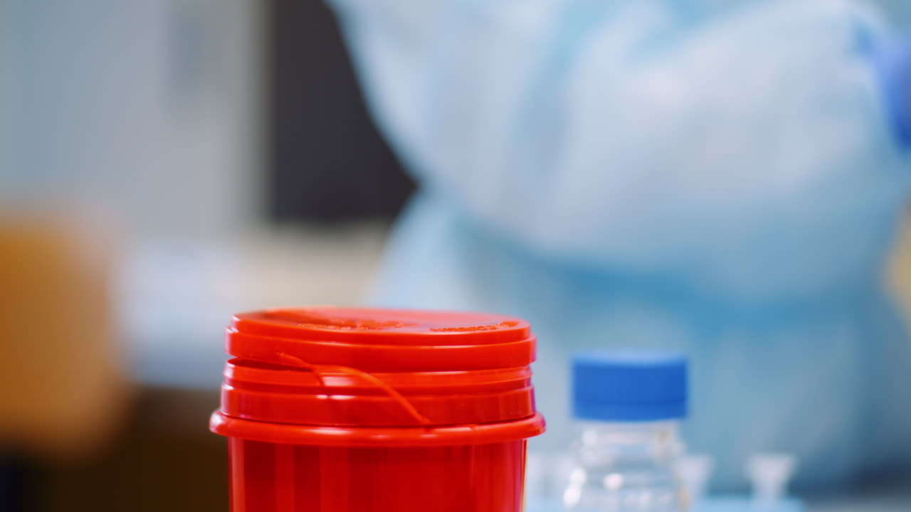 Scientist disposes used test tube in lab