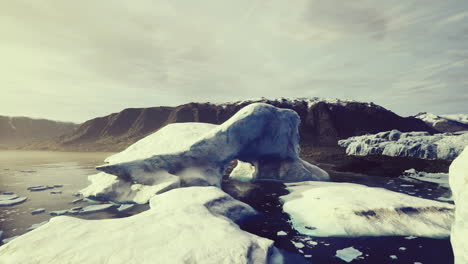 icebergs floating in a serene arctic landscape during sunset hours
