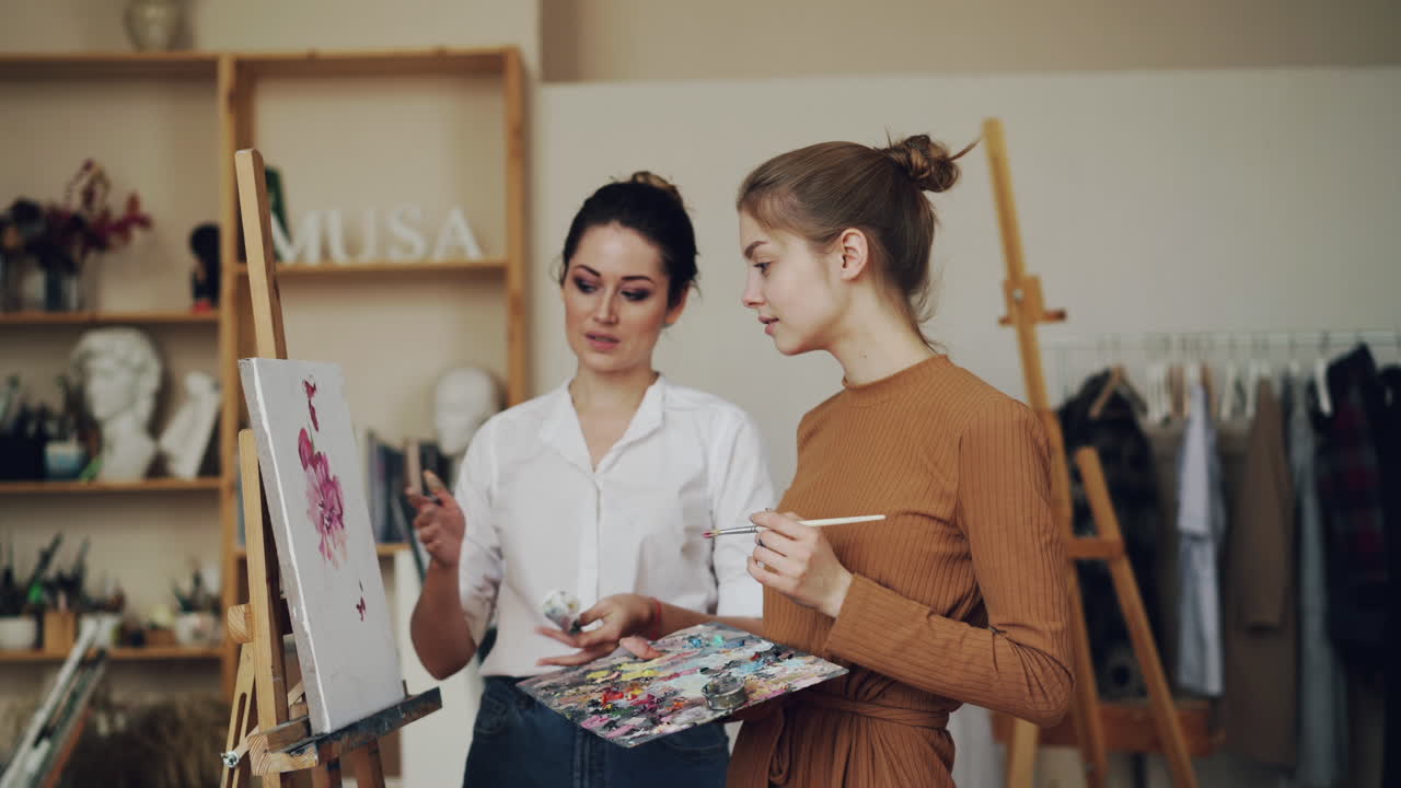 Woman Teaching a Young Woman to Paint Flowers